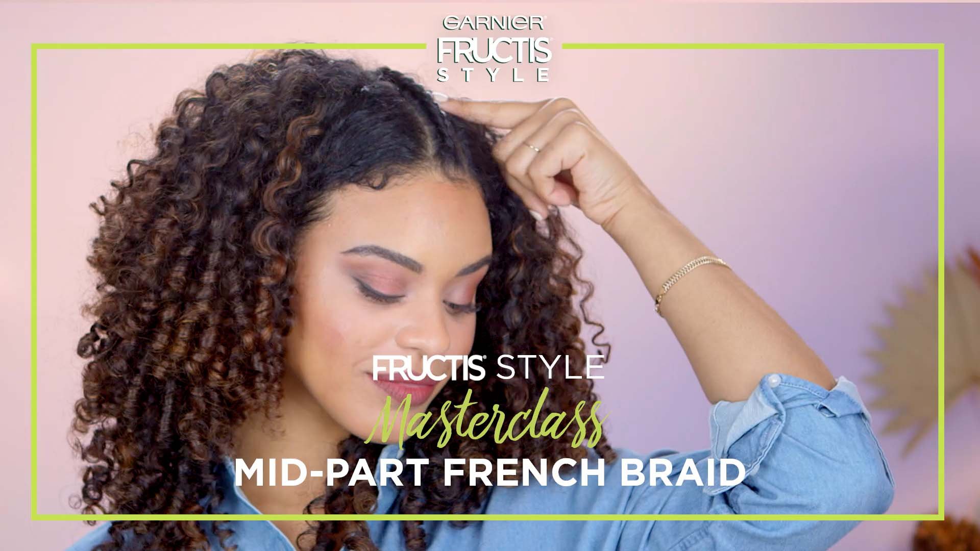 Girl looking down at an angle with a Mid-Part French Braid hairstyle.